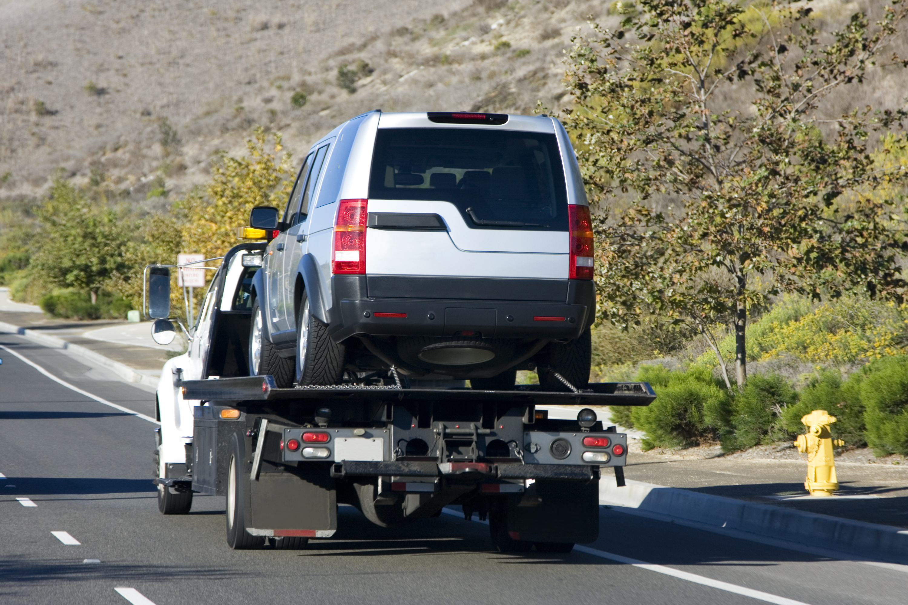 Silver SUV being towed